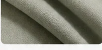 Folded sage clinic blanket representing rest and recovery